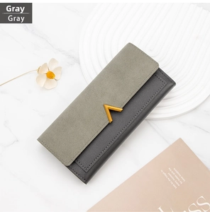 Detail of grey PU leather long wallet with gold V-shape metal trim and stitch work