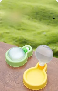 Close-up of portable pet water bottle with wide bowl base in yellow and green colors