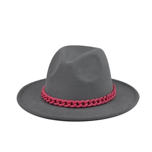 Detail of gray felt fedora hat featuring a chunky magenta decorative chain strap