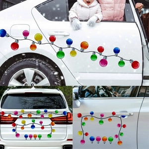 Detailed view of colorful magnetic Christmas bulb stickers on a white car door