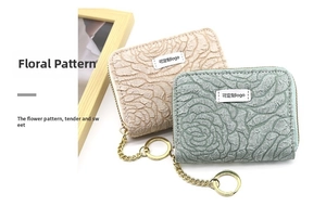 Detailed macro view of 3D rose pattern mini coin purses in beige and light green fabric