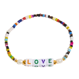 Detailed top view of a colorful beaded LOVE bracelet with pearls on a white background