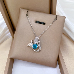 Exquisite silver mermaid necklace with round blue sapphire in a beige jewelry box
