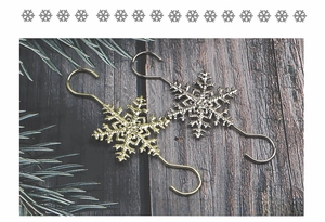 Close-up of gold and silver snowflake metal S-hooks for Christmas tree decorations