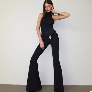 Slim fit black halter neck jumpsuit for women with a gold heart buckle and flared pants