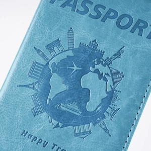 Detail of light blue PU leather passport cover with embossed world travel landmarks