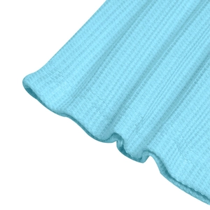 Macro shot of light blue waffle knit fabric showing premium texture and soft cuff detail