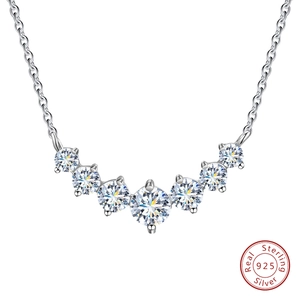 Minimalist 925 sterling silver necklace with seven round sparkling stones in curved row