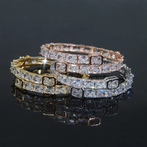Detailed macro view of stacked hip-hop bracelets in gold, silver, and rose gold with zircon