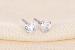 Macro shot of S925 sterling silver heart stud earrings with clear sparkling zircon stones