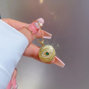 Gold evil eye necklace with green stone and sparkling white crystals for women