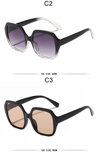 Detail view of large frame sunglasses in black with purple and orange gradient lenses