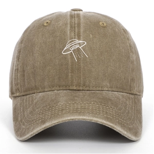 Macro detail of UFO embroidery and washed vintage texture on a khaki baseball cap
