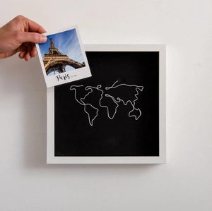 Macro detail of white shadow box frame with world map art for travel ticket souvenirs