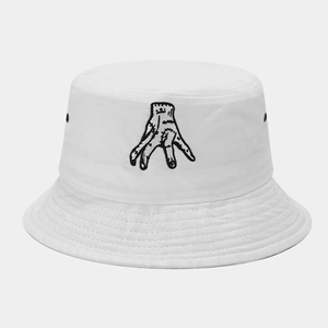 Close-up of black hand embroidery and metallic eyelets on a white cotton bucket hat