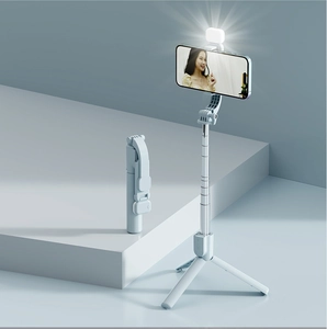 Close-up of light blue selfie stick with integrated ring light and tripod stand