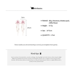 Close-up of pink chiffon flower earrings with long pearl tassels and diamond accents