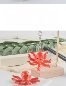 Detailed view of a realistic red octopus keychain with textured skin and metal ring