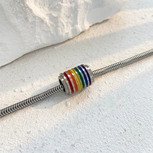 Silver snake chain bracelet featuring a cylindrical rainbow enamel charm for men