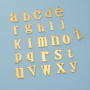 Polished gold stainless steel lowercase A-Z alphabet pendants set on blue background