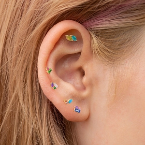 S925 sterling silver cartilage earrings with colorful crystals worn on a female ear