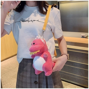 Detailed view of pink plush dinosaur bag featuring soft texture and yellow shoulder strap