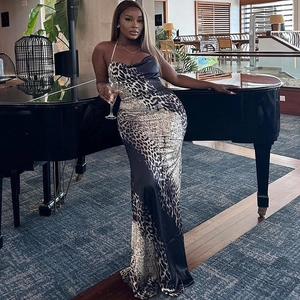 Elegant leopard print halter neck evening dress with black satin fishtail silhouette