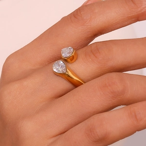 Macro view of gold Toi et Moi open ring featuring dual pear-shaped zirconia stones