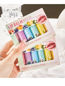 Macro detail of lip balm set featuring fruit extracts, Vitamin E, and honey ingredients