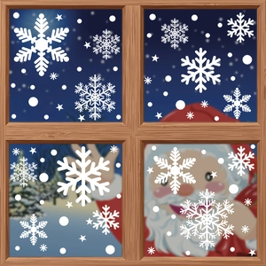 White Christmas snowflake window clings on glass with a snowy blue night background