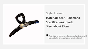 Detail view of 13cm black shark hair claw with large white pearl and rhinestone heart