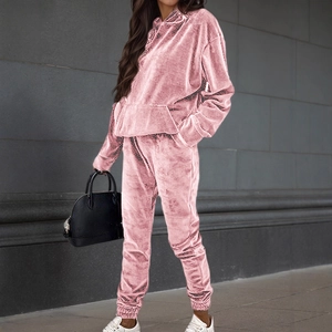 Women's pink velvet two-piece tracksuit featuring hooded sweatshirt and matching joggers