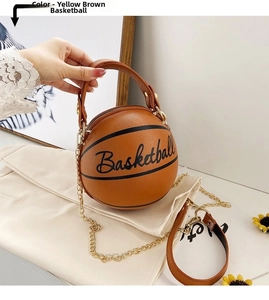 Detail of yellow-brown basketball-shaped handbag with pebbled texture and gold chain