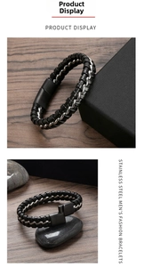 Macro view of woven black leather and stainless steel chain bracelet with magnetic clasp