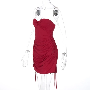 Detail of red tube mini dress featuring side drawstring and elegant ruched fabric