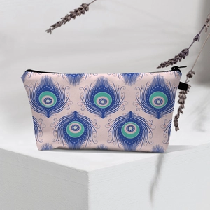 Waterproof travel cosmetic bag with evil eye pattern on a geometric white pedestal