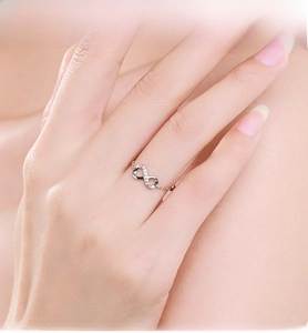 Close-up of adjustable silver infinity ring with micro-pave zircons on a model's finger
