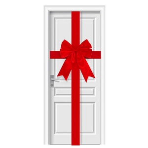 Detail of a large red satin ribbon bow for Christmas door decoration with cross-wrap design