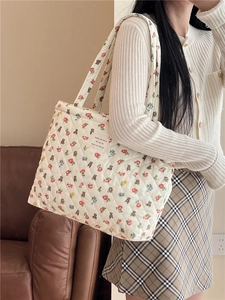 Close-up of quilted tote bag with vintage bear and floral patterns on white fabric