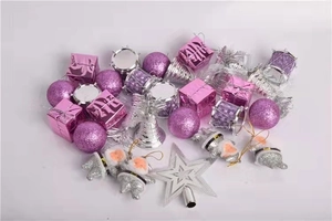 Detailed assortment of pink and silver Christmas ornaments including baubles and stars