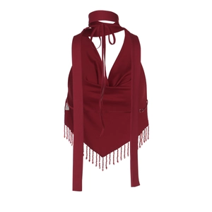 Detail of dark red backless halter top featuring tiered fringe hem and silky fabric texture