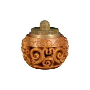Carved green sandalwood sachet pendant with hollow pattern and metal cap on white background