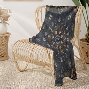 Astrology floral pattern soft flannel blanket with moon phases and sun on woven chair