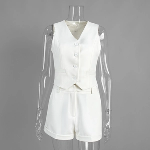 Detail of white two-piece suit set featuring V-neck waistcoat and high-waist shorts