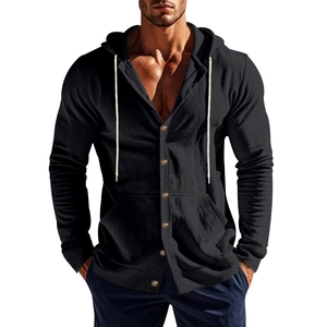 Detail view of black linen hooded shirt showing wood-style buttons and white drawstring