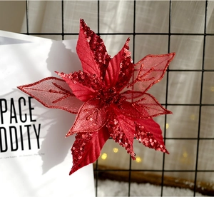 Detail of red sequined artificial poinsettia with mesh petals for Christmas decor
