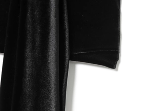 Detailed macro view of premium black velvet fabric texture with precise stitching