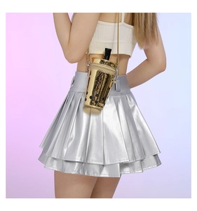Detail of creative bubble tea cup cross body bag paired with metallic pleated skirt