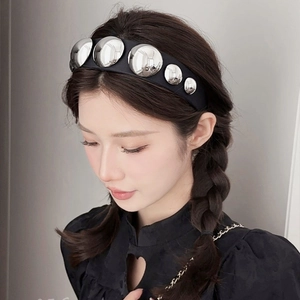 Wide black fabric headband with large silver ball studs shown on model for women