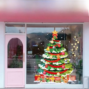 Detailed view of green Christmas tree window sticker with colorful gift boxes on glass shop door